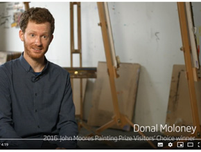 Photo of academic in front of easels